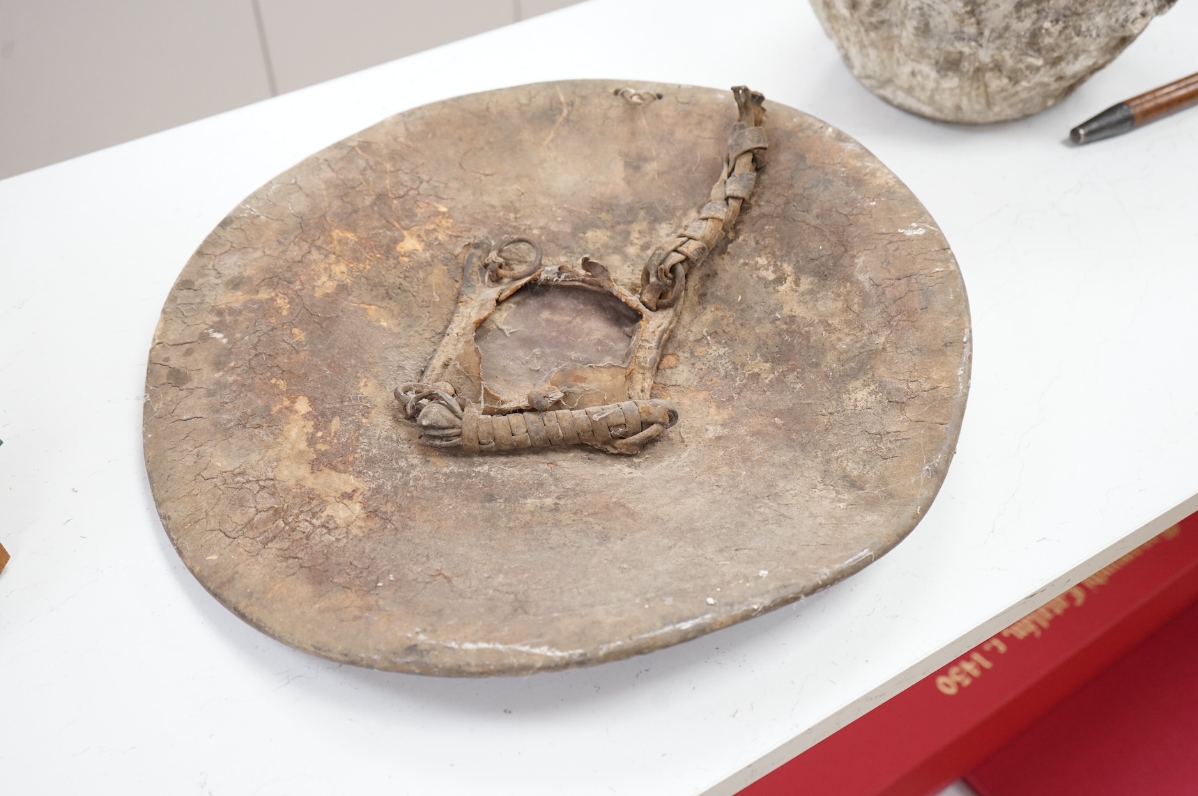 An Indian hide shield or dhal with four roundels, 47cm in diameter